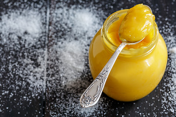 Image showing Lemon custard in a teaspoon and glass jar.