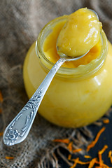 Image showing Jar with lemon custard and a teaspoon.