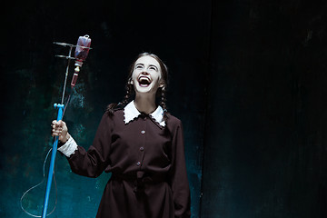 Image showing Portrait of a young girl in school uniform as a vampire woman