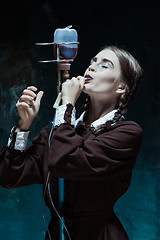 Image showing Portrait of a young girl in school uniform as a vampire woman