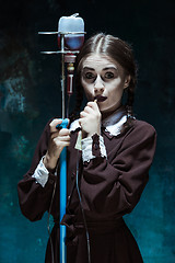 Image showing Portrait of a young girl in school uniform as a vampire woman