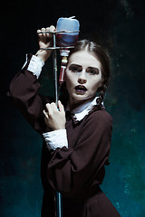 Image showing Portrait of a young girl in school uniform as a vampire woman
