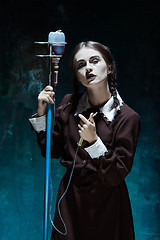 Image showing Portrait of a young girl in school uniform as a vampire woman