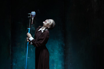 Image showing Portrait of a young girl in school uniform as a vampire woman