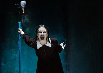 Image showing Portrait of a young girl in school uniform as a vampire woman