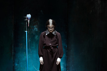 Image showing Portrait of a young girl in school uniform as a vampire woman