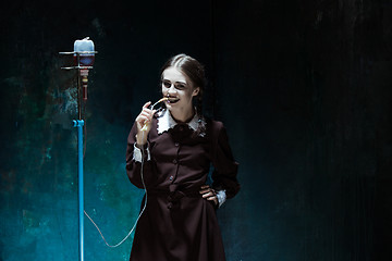 Image showing Portrait of a young girl in school uniform as a vampire woman