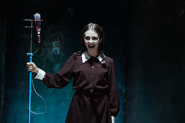 Image showing Portrait of a young girl in school uniform as a vampire woman