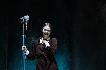 Image showing Portrait of a young girl in school uniform as a vampire woman