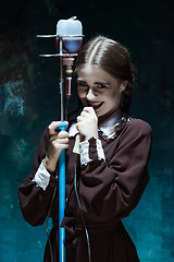 Image showing Portrait of a young girl in school uniform as a vampire woman