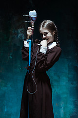 Image showing Portrait of a young girl in school uniform as a vampire woman