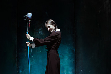 Image showing Portrait of a young girl in school uniform as a vampire woman