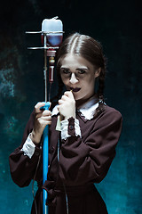 Image showing Portrait of a young girl in school uniform as a vampire woman