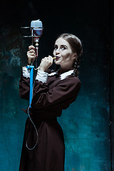 Image showing Portrait of a young girl in school uniform as a vampire woman