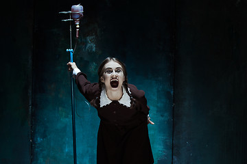 Image showing Portrait of a young girl in school uniform as a vampire woman