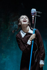 Image showing Portrait of a young girl in school uniform as a vampire woman