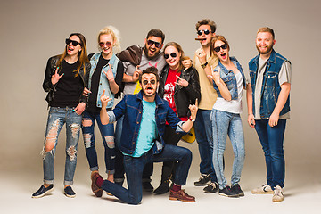 Image showing Group of happy young friends in blue jeans