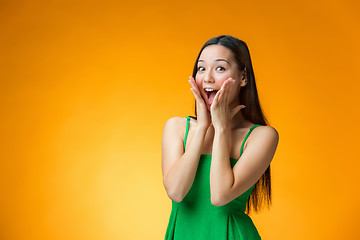 Image showing The surprised Chinese girl on yellow background