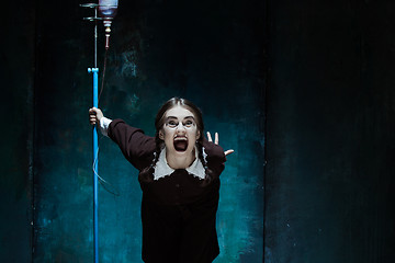 Image showing Portrait of a young girl in school uniform as a vampire woman