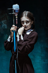 Image showing Portrait of a young girl in school uniform as a vampire woman