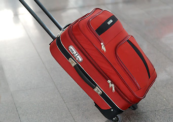 Image showing Convenient suitcase on wheels with handle.