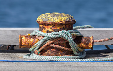Image showing Metal bollard with ropes