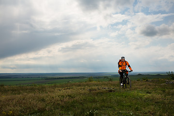 Image showing Young man is riding bicycle outside. Healthy Lifestyle.