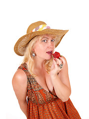 Image showing Woman eating strawberry.