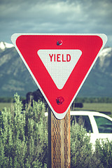 Image showing Large red yield sign in a countryside