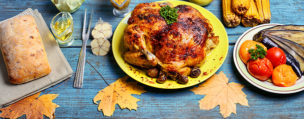 Image showing Roasted chicken on wooden plate