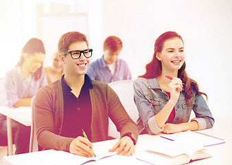 Image showing smiling students with notebooks at school