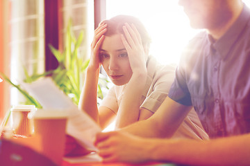 Image showing creative team with reading paper in office