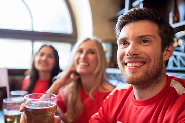 Image showing fans or friends watching football at sport bar