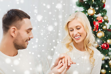 Image showing man giving woman engagement ring for christmas