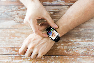 Image showing close up of hands with incoming call on smartwatch