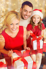 Image showing happy family opening gift boxes