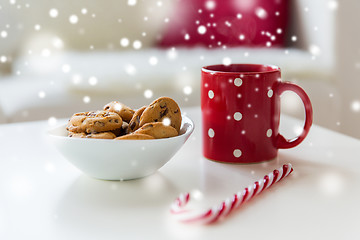 Image showing close up of oat cookies, sugar cane candy and cup