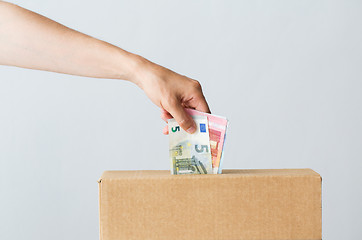 Image showing man putting euro money into donation box