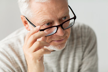 Image showing close up of senior man in glasses thinking