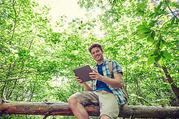 Image showing happy man with backpack and tablet pc in woods