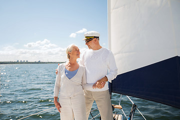 Image showing senior couple hugging on sail boat or yacht in sea