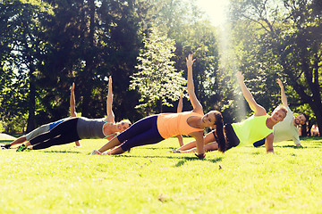 Image showing group of happy friends exercising outdoors