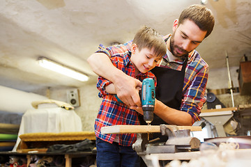 Image showing father and son with drill working at workshop