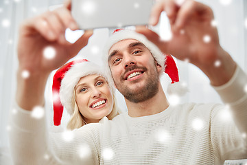 Image showing couple taking selfie with smartphone at christmas