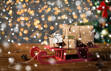 Image showing close up of christmas gift boxes on wooden sleigh