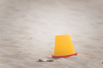 Image showing Yellow bucket on a beach