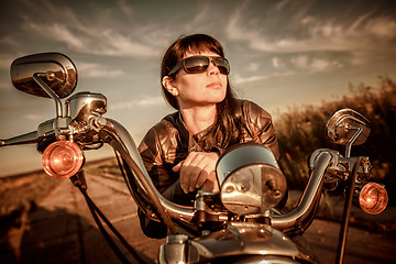 Image showing Biker girl sitting on motorcycle