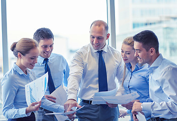 Image showing business people with papers talking in office