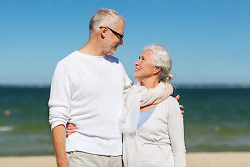 Image showing happy senior couple hugging on summer beach