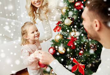 Image showing happy family decorating christmas tree at home